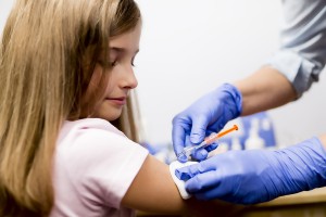 Vaccine - a doctor giving vaccination girl, health, prevention